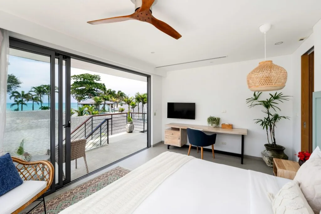 Two Villas, One Estate: A combined 10-Bedroom Private Estate near Phuket for Large Groups | Twin Villas Natai Ocean-view bedroom at Twin Villas Natai with ensuite and sea vista — 10 bedroom villa Phuket, Natai double villa private.