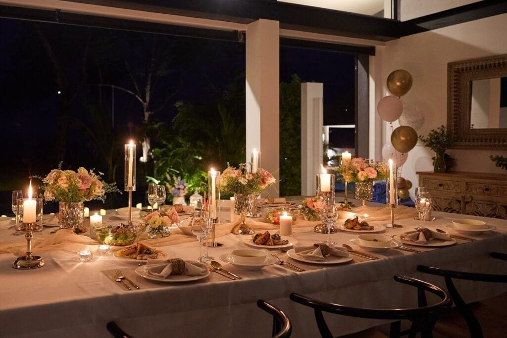 Phuket wedding villa dinner table with floating pool candles at Twin Villas Natai