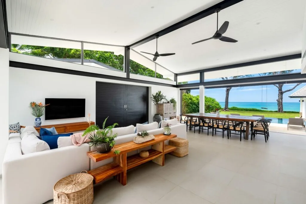 Two Villas, One Estate: A combined 10-Bedroom Private Estate near Phuket for Large Groups | Twin Villas Natai North Villa living room with sliding doors closed for privacy — Natai double villa private, exclusive villas Phuket.