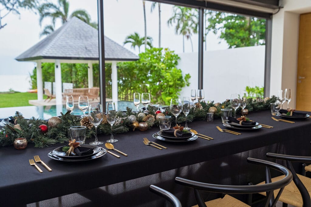 Stylish Christmas dinner table overlooking the private pool and pavilion at Twin Villas Natai, blending festive décor with tropical villa luxury for a Phuket Christmas celebration
