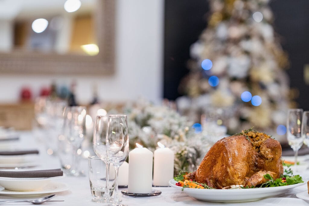 Close-up of a beautifully roasted Christmas turkey with glowing candles and festive décor at Twin Villas Natai, perfect for families celebrating Christmas in a private Phuket villa.
