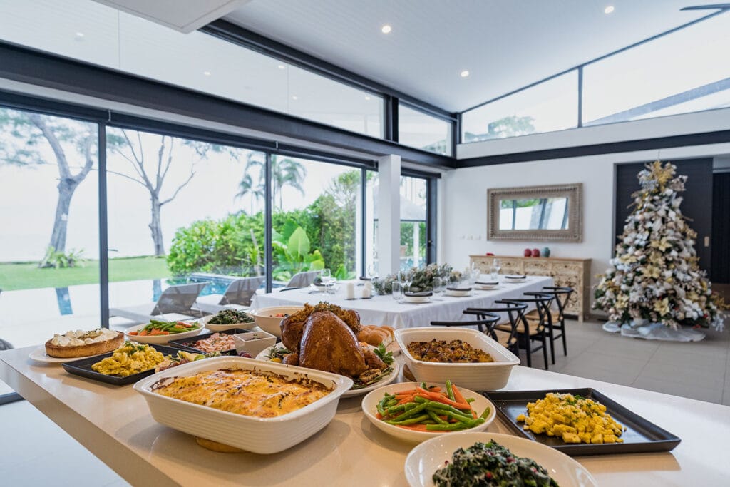 Holiday feast with roast turkey, sides, and Christmas dishes prepared by the private chef at Twin Villas Natai, set inside a bright beachfront villa for a tropical Christmas celebration in Thailand.
