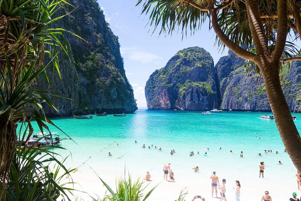The world-famous Maya Bay on Phi Phi Leh island with crystal clear turquoise water and white sand beach, a top-rated day trip for families.
