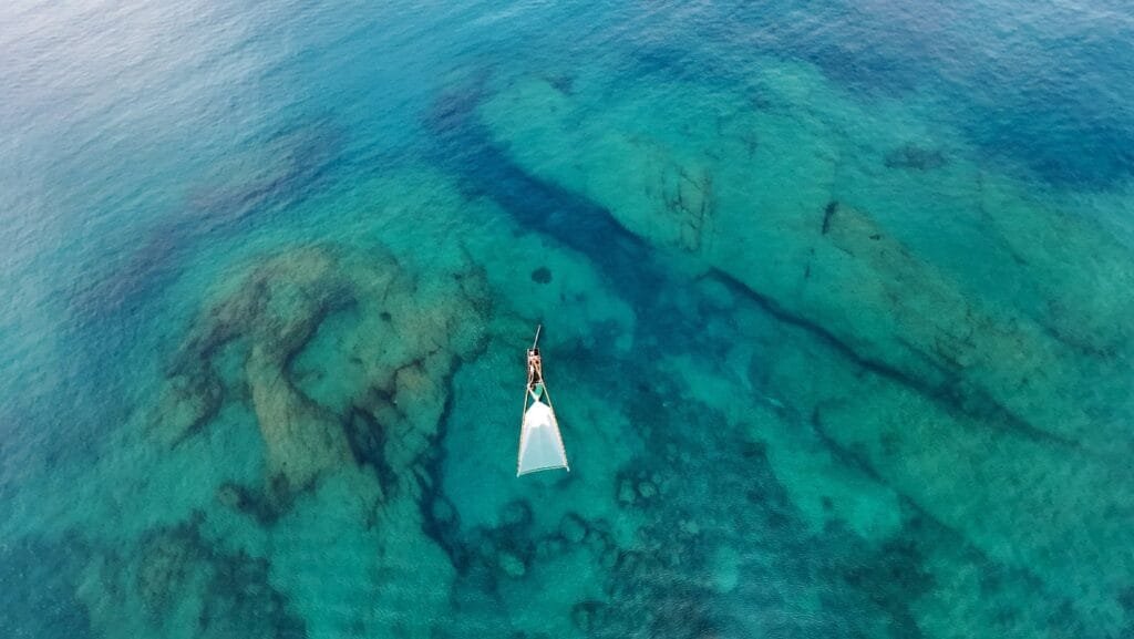 Shallow coral reef in front of Twin Villas Natai, visible from above, offering snorkeling and kayaking directly from the private beachfront villa in Phuket, Thailand.