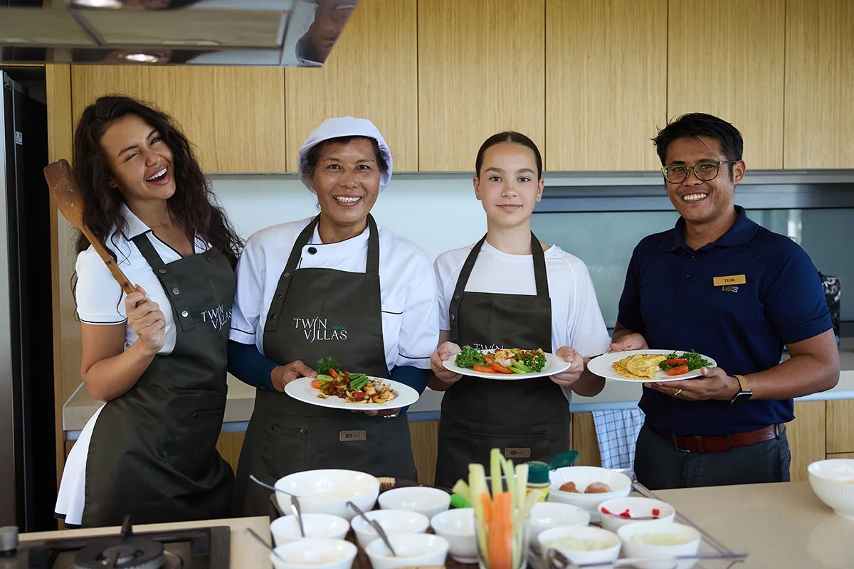 Top Family Activities In and Around Natai Beach | Twin Villas Natai Guests participating in a private Thai cooking class at Twin Villas Natai with the professional villa chef and villa manager guiding the culinary experience.