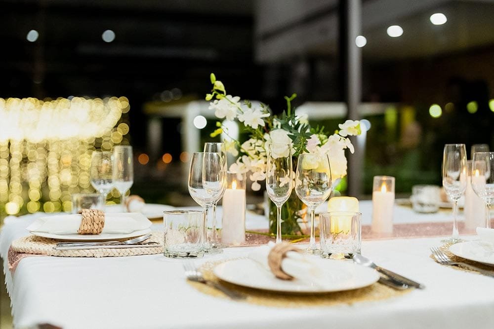 Retreat Villas Near Phuket – A Private Beachfront Wellness Sanctuary at Twin Villas Natai | Twin Villas Natai Intimate retreat celebration dinner with white floral decor and warm candlelight inside a luxury villa setting