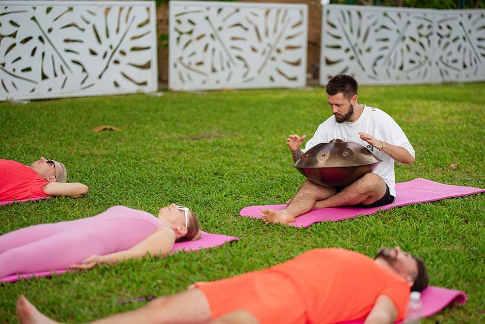Retreat Villas Near Phuket – A Private Beachfront Wellness Sanctuary at Twin Villas Natai | Twin Villas Natai Outdoor sound healing session in a secluded villa garden, creating an uninterrupted and intimate retreat experience.
