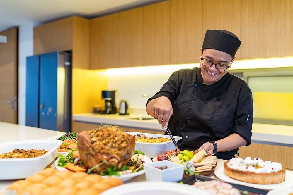 Retreat Villas Near Phuket – A Private Beachfront Wellness Sanctuary at Twin Villas Natai | Twin Villas Natai Private chef arranging freshly prepared dishes with local ingredients for a customized retreat menu