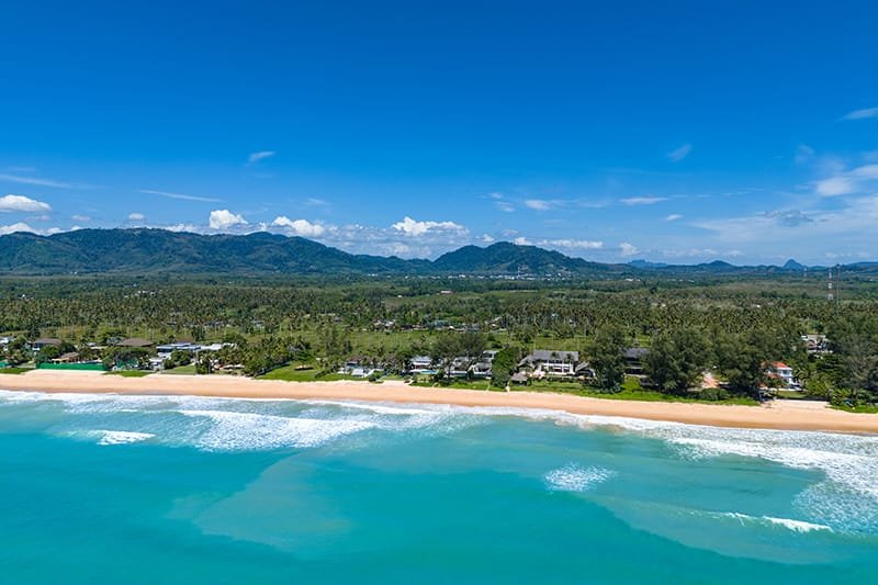 Discover Phang Nga Attractions: The Best Day Trips from Natai Beach, Thailand | Twin Villas Natai Aerial view of Natai Beach in Phang Nga, Thailand, with long shoreline and clear Andaman Sea waters.