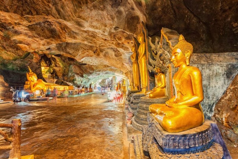 Discover Phang Nga Attractions: The Best Day Trips from Natai Beach, Thailand | Twin Villas Natai Golden Buddha statues inside the Monkey Cave Temple in Phang Nga, Thailand.