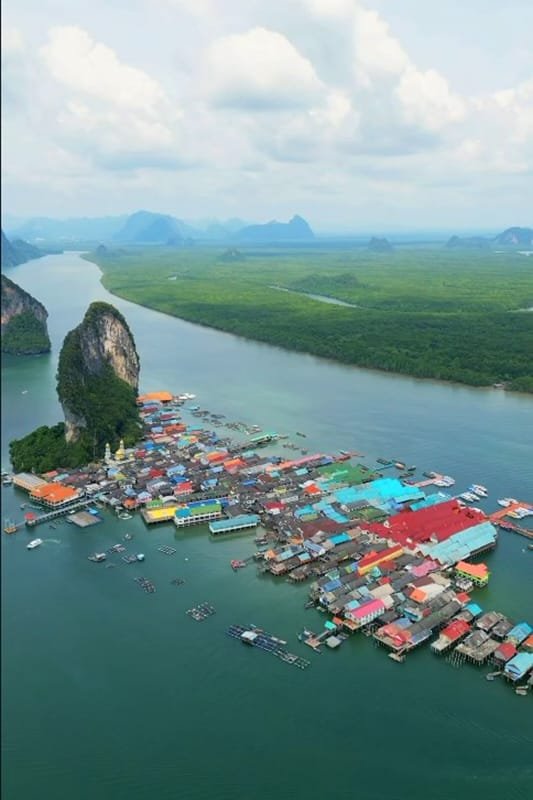 Natai Beach or Phuket? The Discerning Traveler’s Guide to Privacy and Access | Twin Villas Natai Aerial view of Koh Panyee village built on stilts over the water in Phang Nga Bay, Thailand.