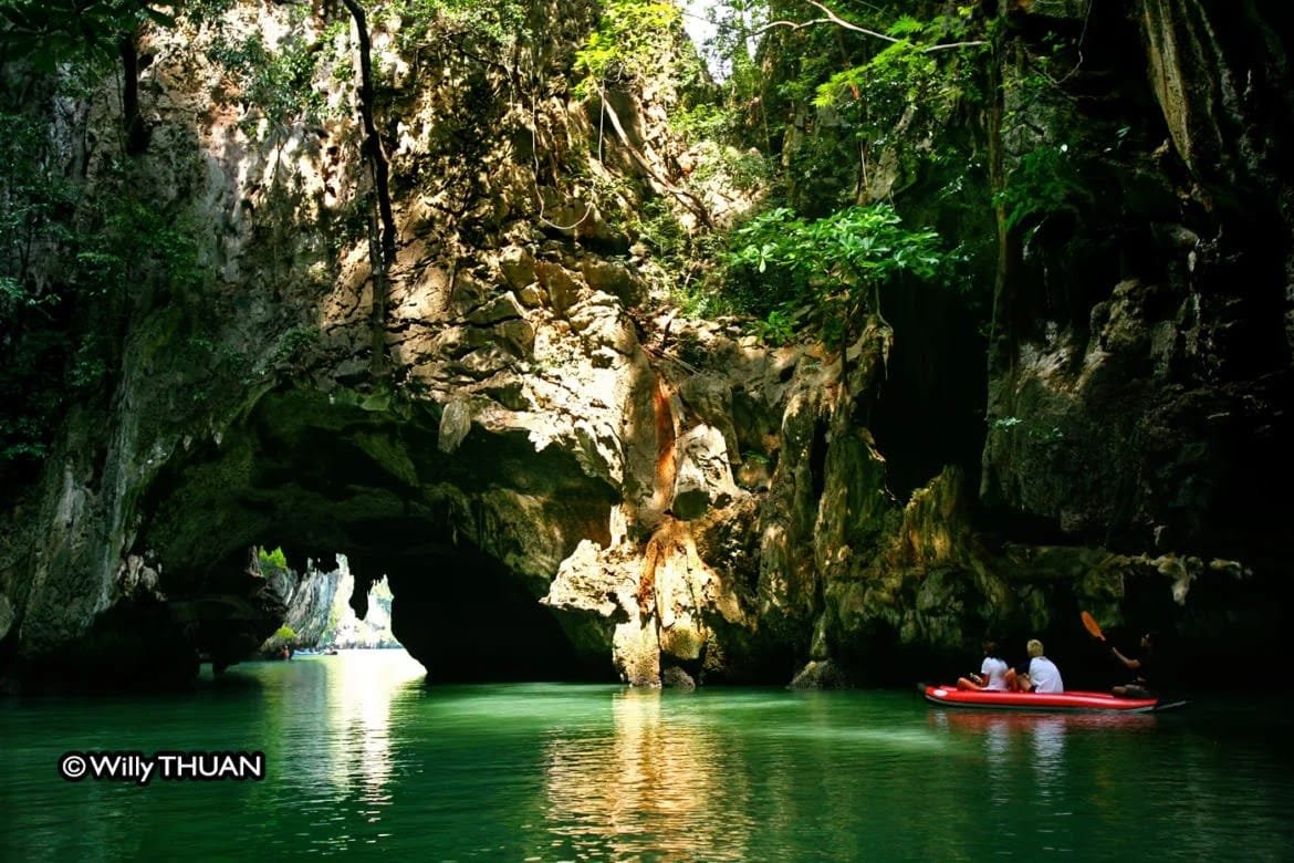 Natai Beach or Phuket? The Discerning Traveler’s Guide to Privacy and Access | Twin Villas Natai Guided sea canoe entering a limestone cave at Koh Hong in Phang Nga Bay during a favorable tidal window.