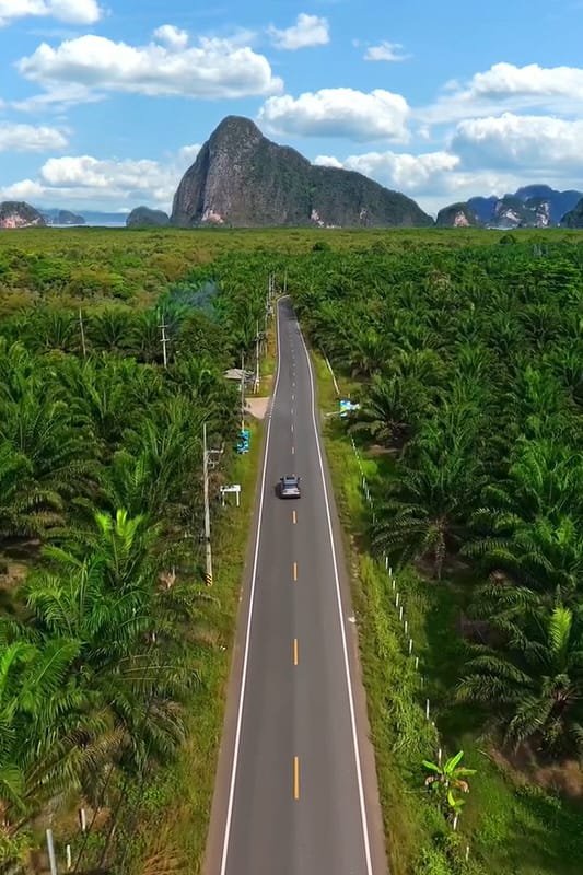 Discover Phang Nga Attractions: The Best Day Trips from Natai Beach, Thailand | Twin Villas Natai Quiet two-lane road in Phang Nga leading toward Summit Nangshe with minimal traffic.