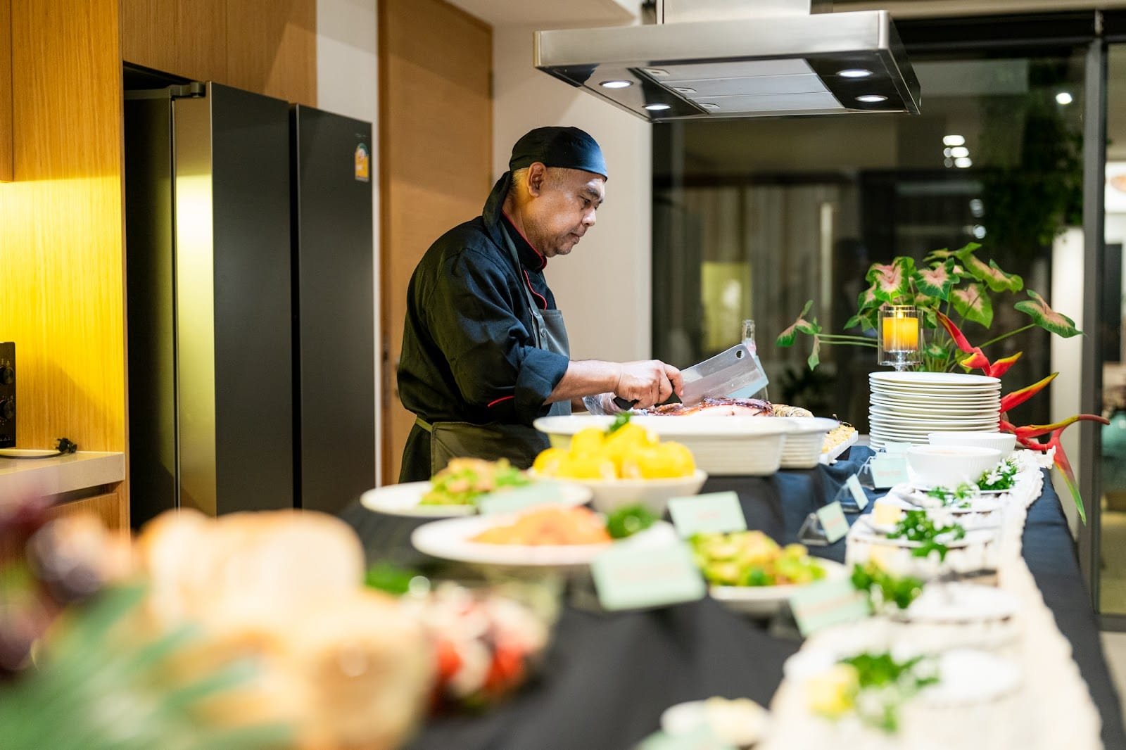 Natai Beach or Phuket? The Discerning Traveler’s Guide to Privacy and Access | Twin Villas Natai Private chef preparing food inside Twin Villas Natai in Phang Nga, Thailand.